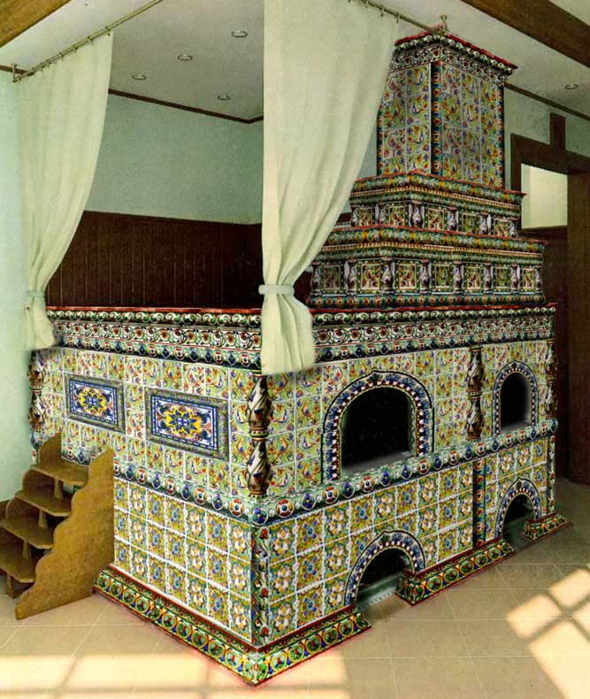 A spectacular example of a tile-covered Russian stove, in the peasant style with a space for sleeping on top.  See more about these tiles and stoves below.